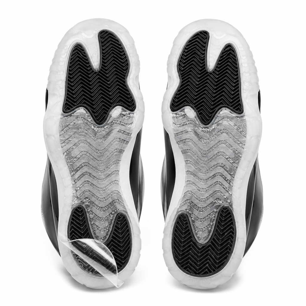 Pair of sneaker outsoles with Ultimate Sole Protectors clear film applied, one corner lifted to show the film peeling away cleanly